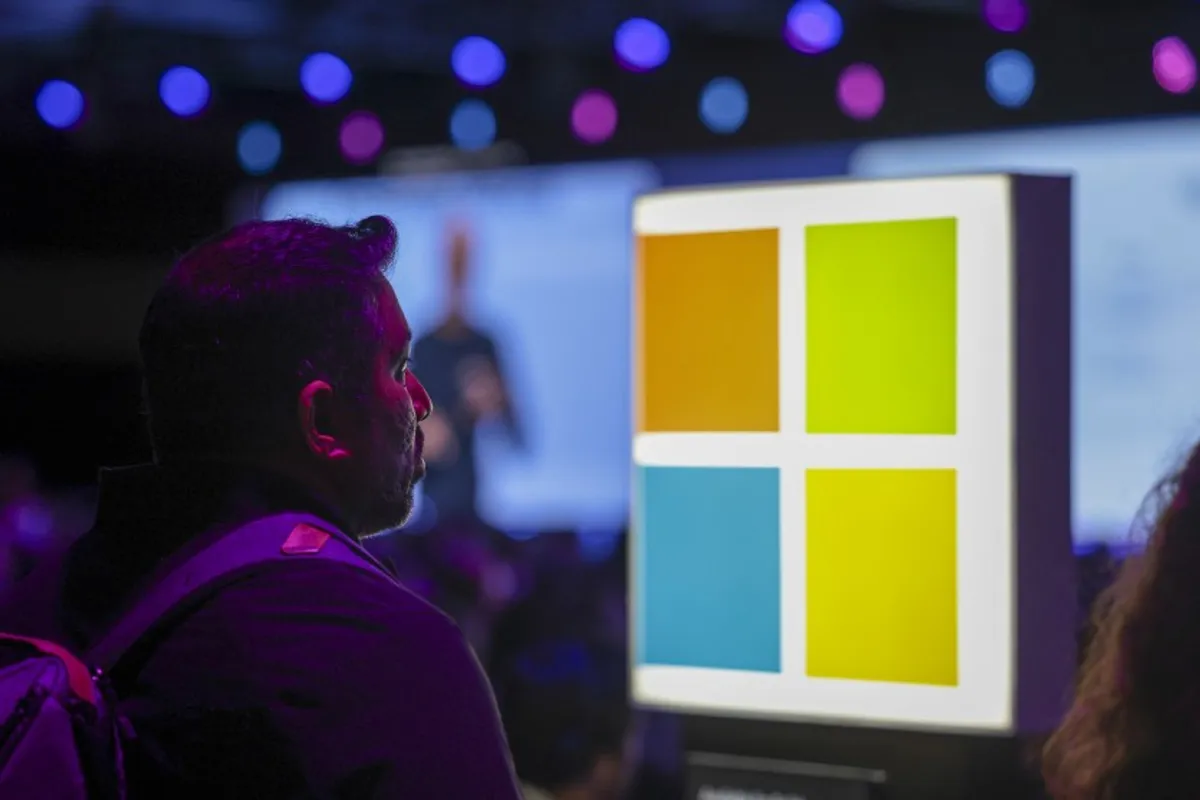 Audience member at Microsoft Build 2026 opening keynote with Microsoft logo on stage