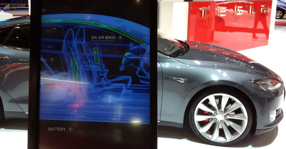 Tesla touchscreen and car at an auto show